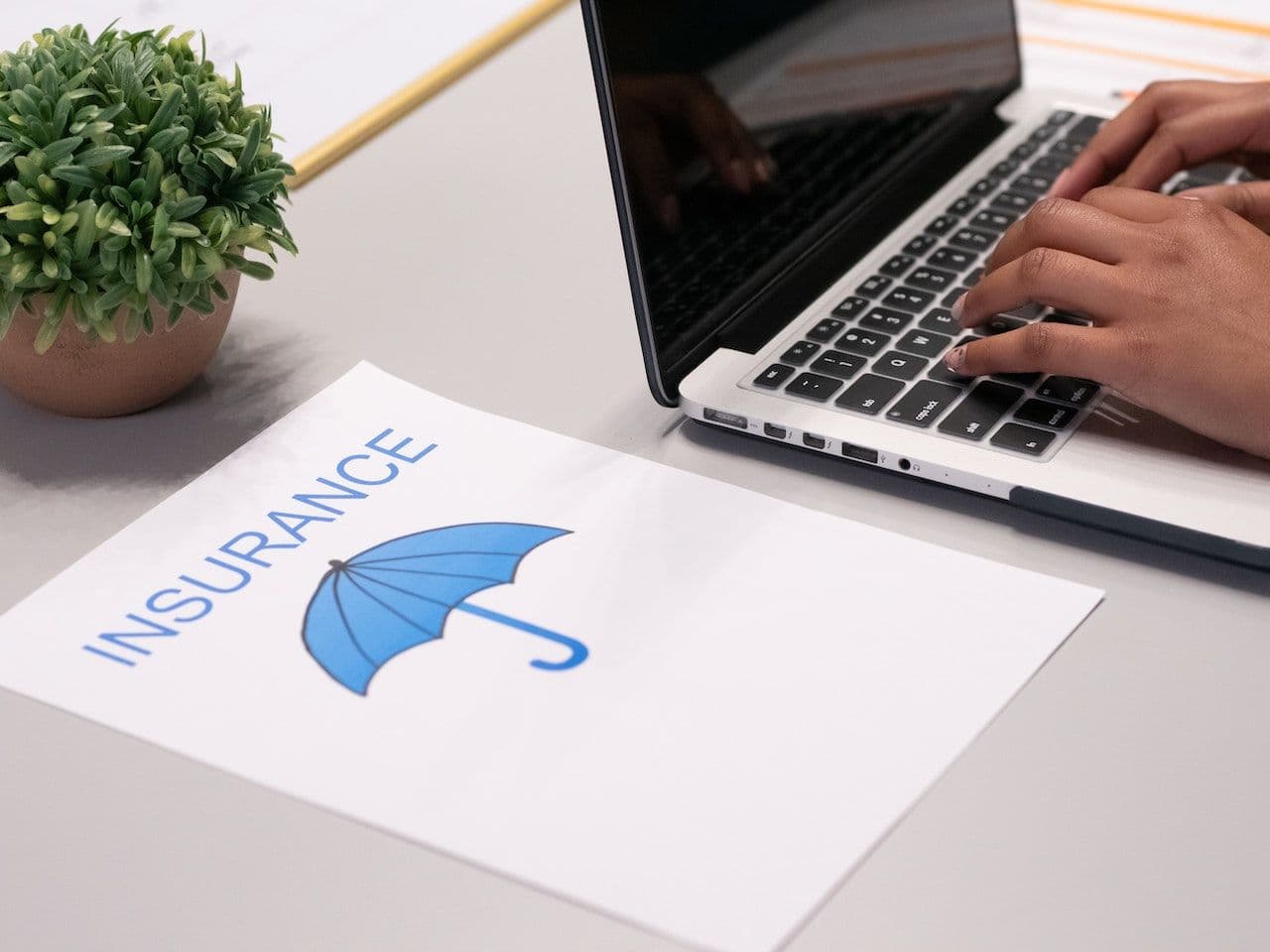 A paper that's written on it 'insurance' sitting on a desk